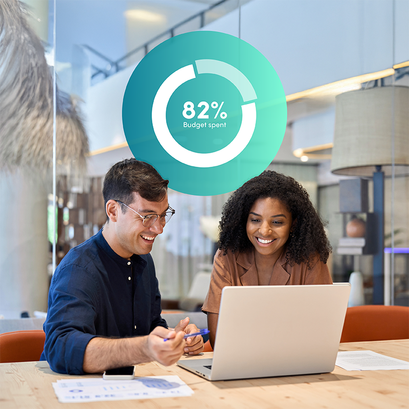 Business people reviewing Elevate labour management system with budget spend graphic, ensuring budget confidence for aviation workforce management.