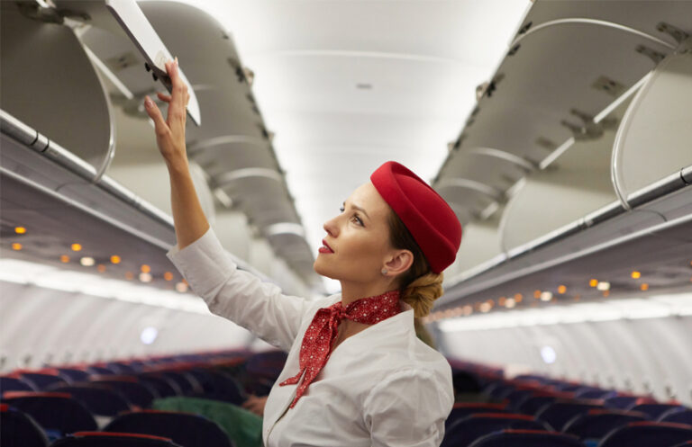 Cabin crew member on an aeroplane, demonstrating how Elevate workforce scheduling software optimises aviation operations for compliant shifts