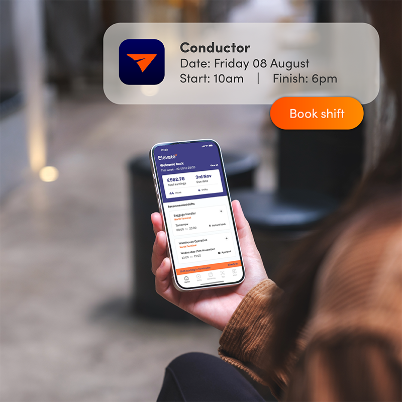 Person using Elevate app on phone with conductor job notification, demonstrating easy shift booking for rail staff scheduling.