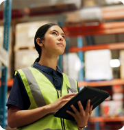 Young warehouse worker in high-vis happily on shift, symbolising an engaged and efficient workforce managed by Elevate logistics solutions.